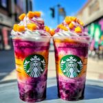 Tropical meteor frappuccino with mango and berry swirling layers