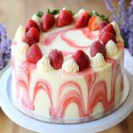 White chocolate strawberry swirl cake on cake stand