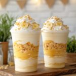 Creamy banana pudding cheesecake frappuccino with whipped cream and vanilla wafers