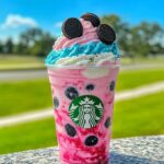Colorful unicorn Oreo frappuccino with whipped cream and rainbow sprinkles