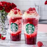 Vibrant red strawberry frappuccino with whipped cream and strawberry drizzle