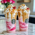 Creamy caramel white chocolate strawberry frappuccino with whipped cream and drizzles
