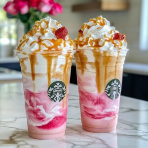 Creamy caramel white chocolate strawberry frappuccino with whipped cream and drizzles