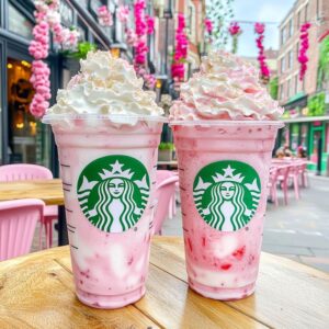 Pink white chocolate strawberry frappuccino with whipped cream and drizzles