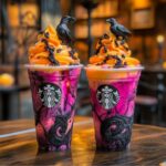 Wednesday Addams Mango Dragon Frappuccino in a glass with whipped cream, charcoal dust, and raven cookie