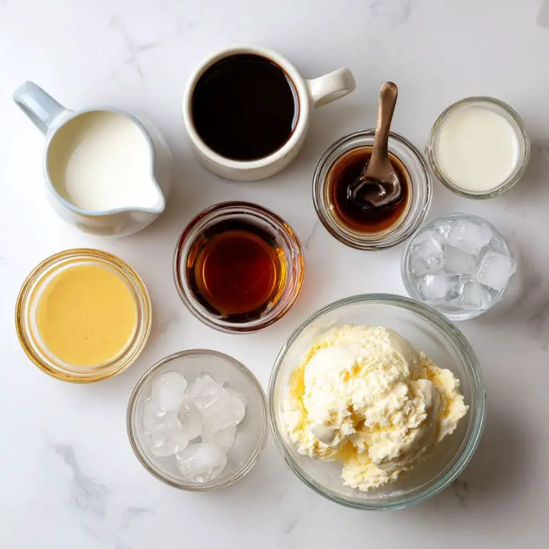 Flat lay of labeled ingredients for Jack Skellington Pumpkin Mocha Frappuccino on white marble